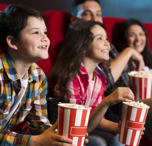happy-family-sitting-cinema-scaled