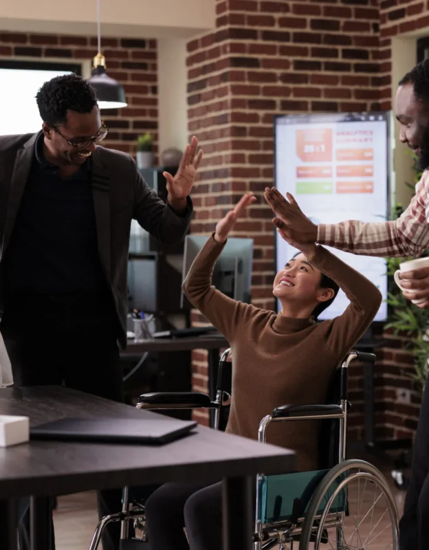 multiethnic-group-people-having-fun-work-break-laughing-enjoying-conversation-with-paralyzed-employee-woman-living-with-physical-chronic-disability-wheelchair-job-scaled